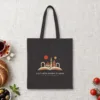 A City with Wisdom to Share Night design on a black canvas tote, laid flat