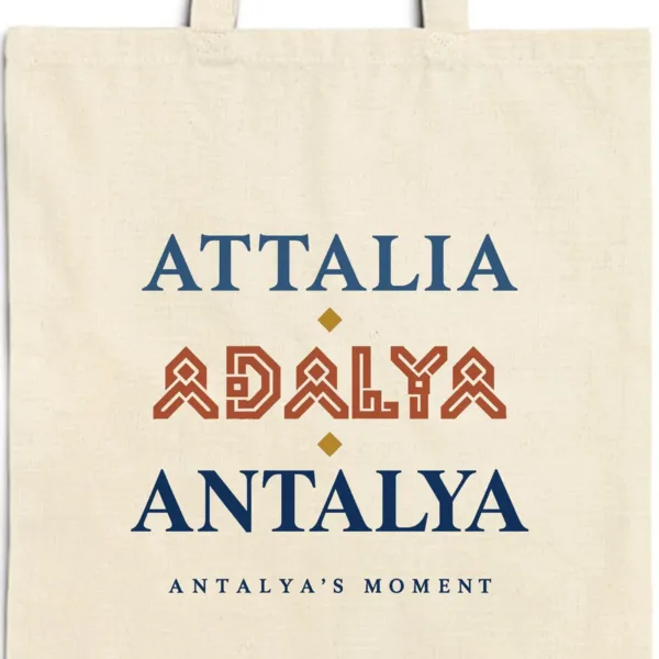 attalia-adalya-antalya-tote-natural-detail-v1 Close-up of the Attalia Adalya Antalya design printed on a natural canvas tote, with the top seam and handles