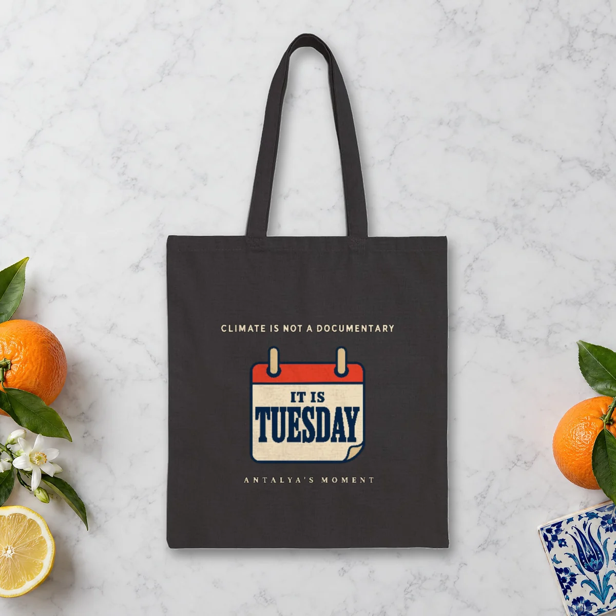 Climate Is Not a Documentary Night design on a black canvas tote, laid flat