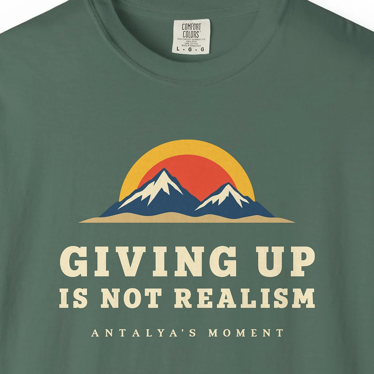 giving-up-is-not-realism-night-tee-blue-spruce-chest-v1 Giving Up Is Not Realism Night Tee in Blue Spruce, close-up