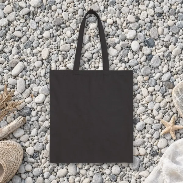 Plain back of the black canvas tote with the Giving Up Is Not Realism Night design, printed on the front only