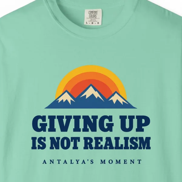 Giving Up Is Not Realism Tee in Island Reef, close-up
