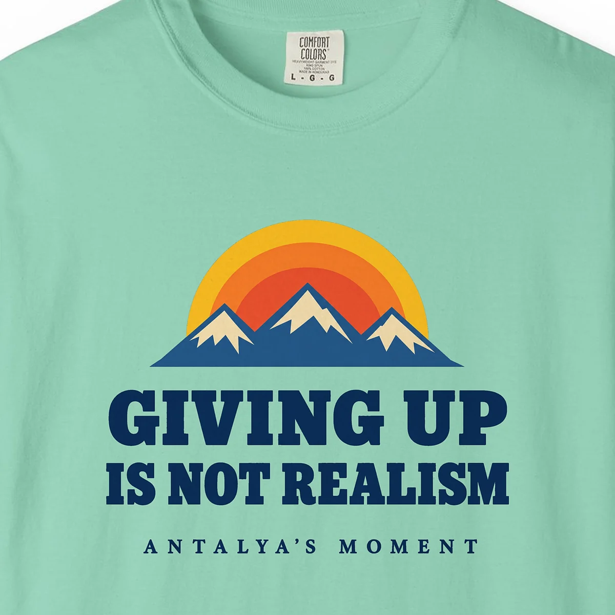 Giving Up Is Not Realism Tee in Island Reef, close-up