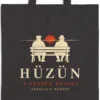 Close-up of the Hüzün Night design printed on a black canvas tote, with the top seam and handles