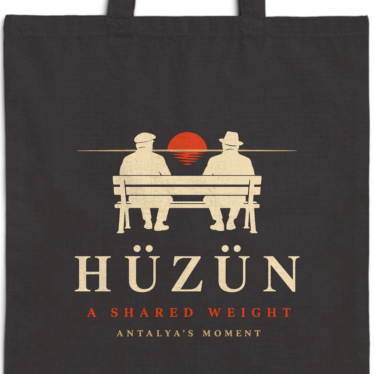Close-up of the Hüzün Night design printed on a black canvas tote, with the top seam and handles