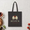 Hüzün Night design on a black canvas tote, laid flat