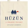 Close-up of the Hüzün design printed on a natural canvas tote, with the top seam and handles