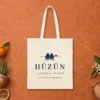 Hüzün design on a natural canvas tote, laid flat