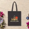 More Than a Venue Night design on a black canvas tote, laid flat