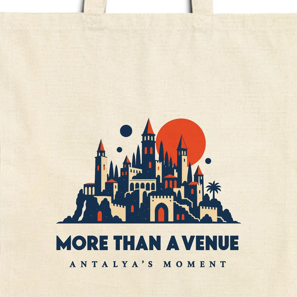 Close-up of the More Than a Venue design printed on a natural canvas tote, with the top seam and handles
