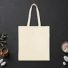 Plain back of the natural canvas tote with the Not as Servers, but as Speakers design, printed on the front only