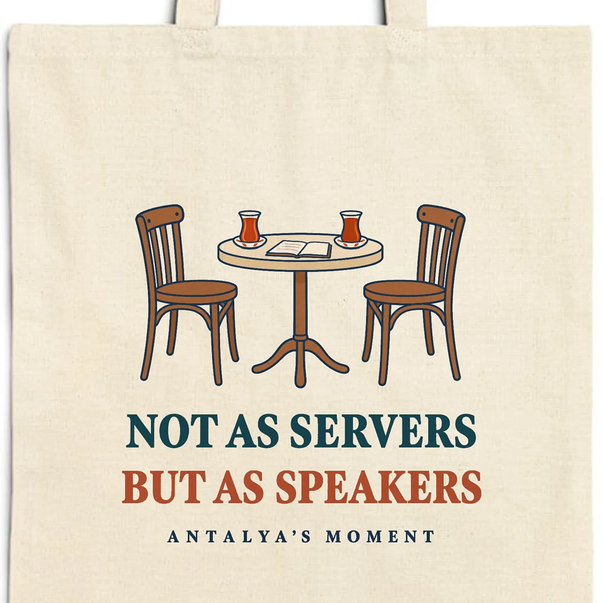 Close-up of the Not as Servers, but as Speakers design printed on a natural canvas tote, with the top seam and handles