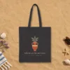 Now We Are the Ancestors Night design on a black canvas tote, laid flat