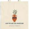 Close-up of the Now We Are the Ancestors design printed on a natural canvas tote, with the top seam and handles