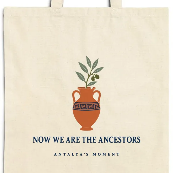 Close-up of the Now We Are the Ancestors design printed on a natural canvas tote, with the top seam and handles