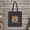 The City Beneath the City Night design on a black canvas tote, laid flat