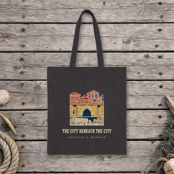 The City Beneath the City Night design on a black canvas tote, laid flat