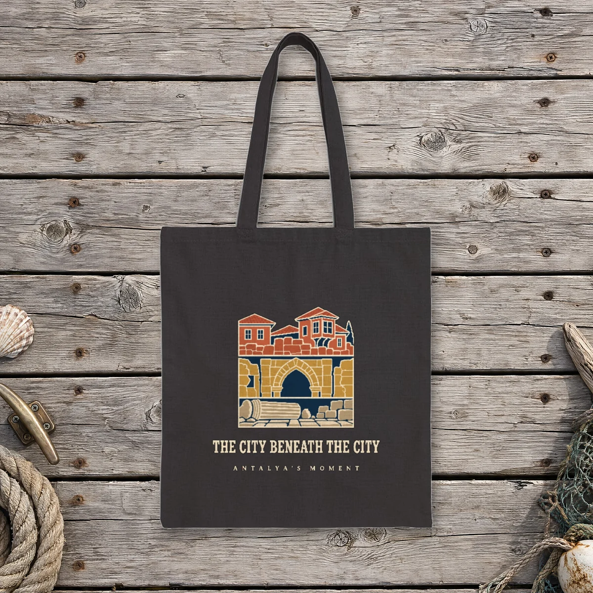 The City Beneath the City Night design on a black canvas tote, laid flat