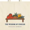 Close-up of the The Wisdom of Enough design printed on a natural canvas tote, with the top seam and handles