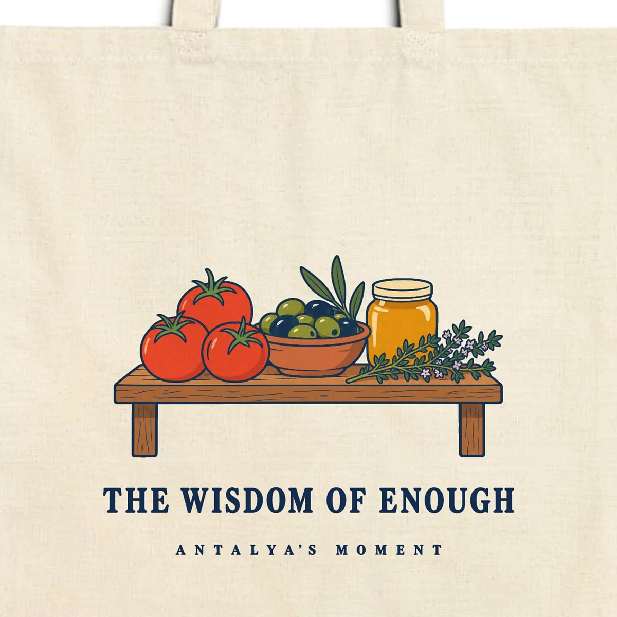 Close-up of the The Wisdom of Enough design printed on a natural canvas tote, with the top seam and handles