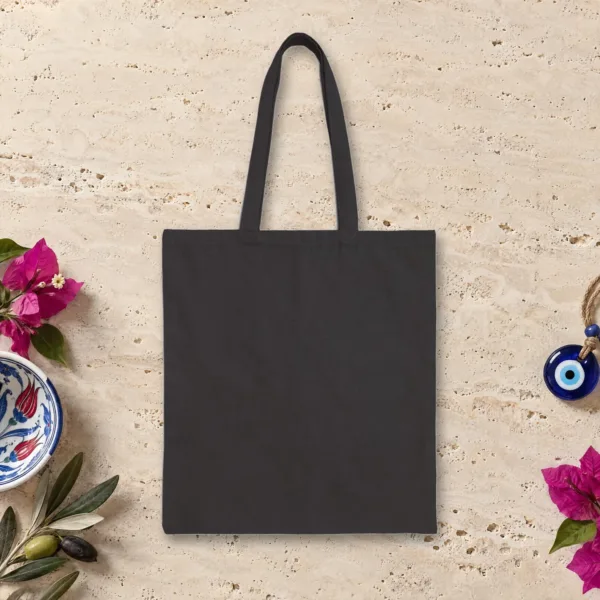 we-will-try-night-tote-black-back-v1 Plain back of the black canvas tote with the We Will Try Night design, printed on the front only