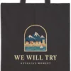 we-will-try-night-tote-black-detail-v1 Close-up of the We Will Try Night design printed on a black canvas tote, with the top seam and handles