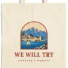 Close-up of the We Will Try design printed on a natural canvas tote, with the top seam and handles