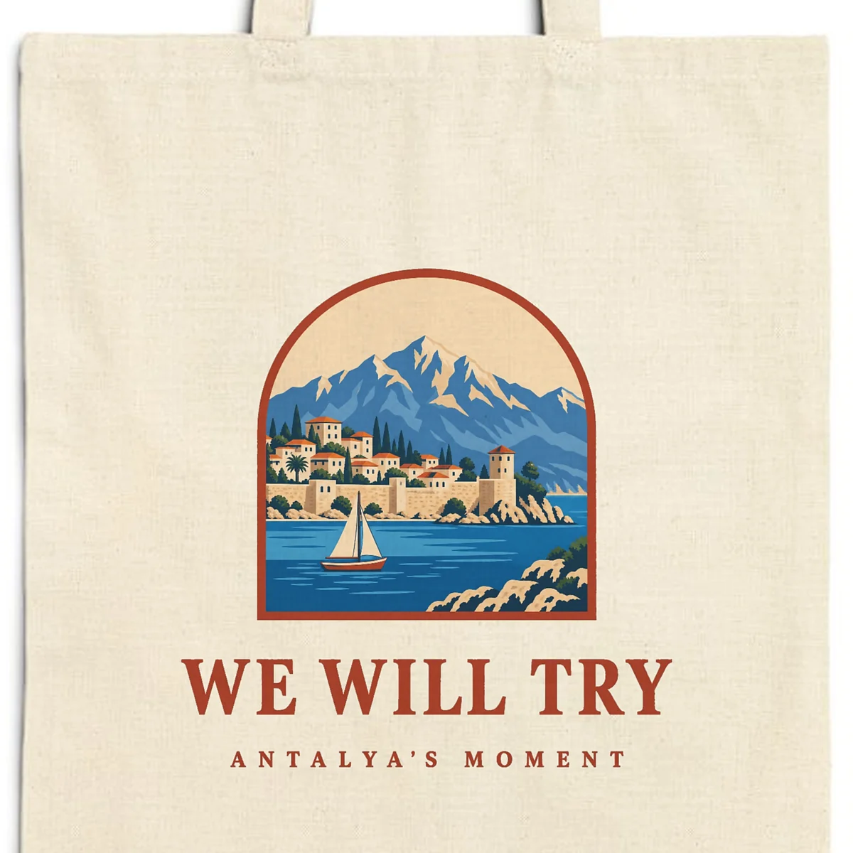 Close-up of the We Will Try design printed on a natural canvas tote, with the top seam and handles
